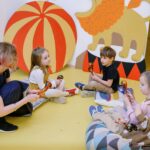 Children and a teacher playing simple instruments and signing