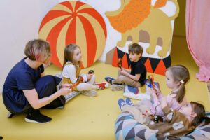 Children and a teacher playing simple instruments and signing