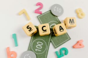 scam spelled out in scrabble tiles