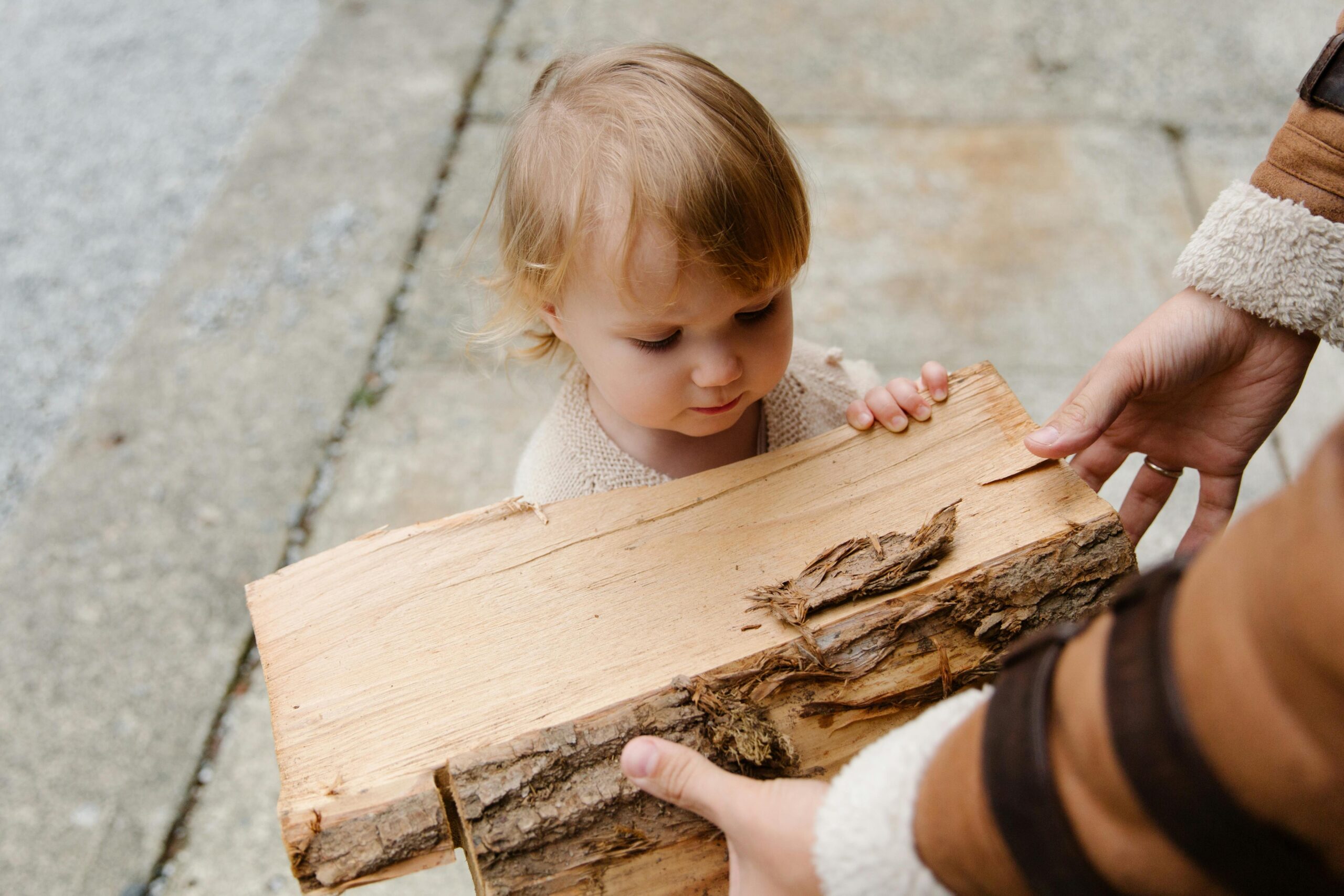 Child touching wood using senses